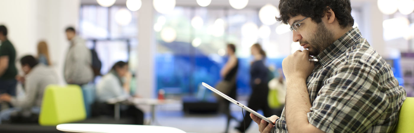 student reading a hand-held device