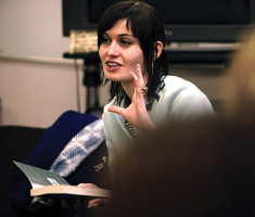 A woman speaking in a discussion.